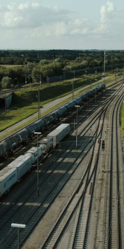 Aerial view of freight train tracks amid lush greenery in Offenburg, Germany.