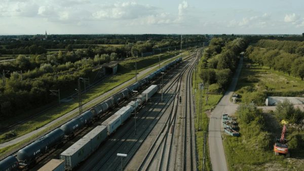 Aerial view of freight train tracks amid lush greenery in Offenburg, Germany.