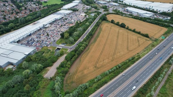 Drone capture of a highway, agricultural field, and shopping center in Bedford, England.